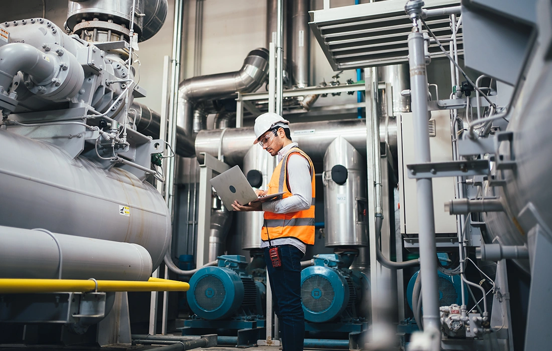 worker in front of pumps