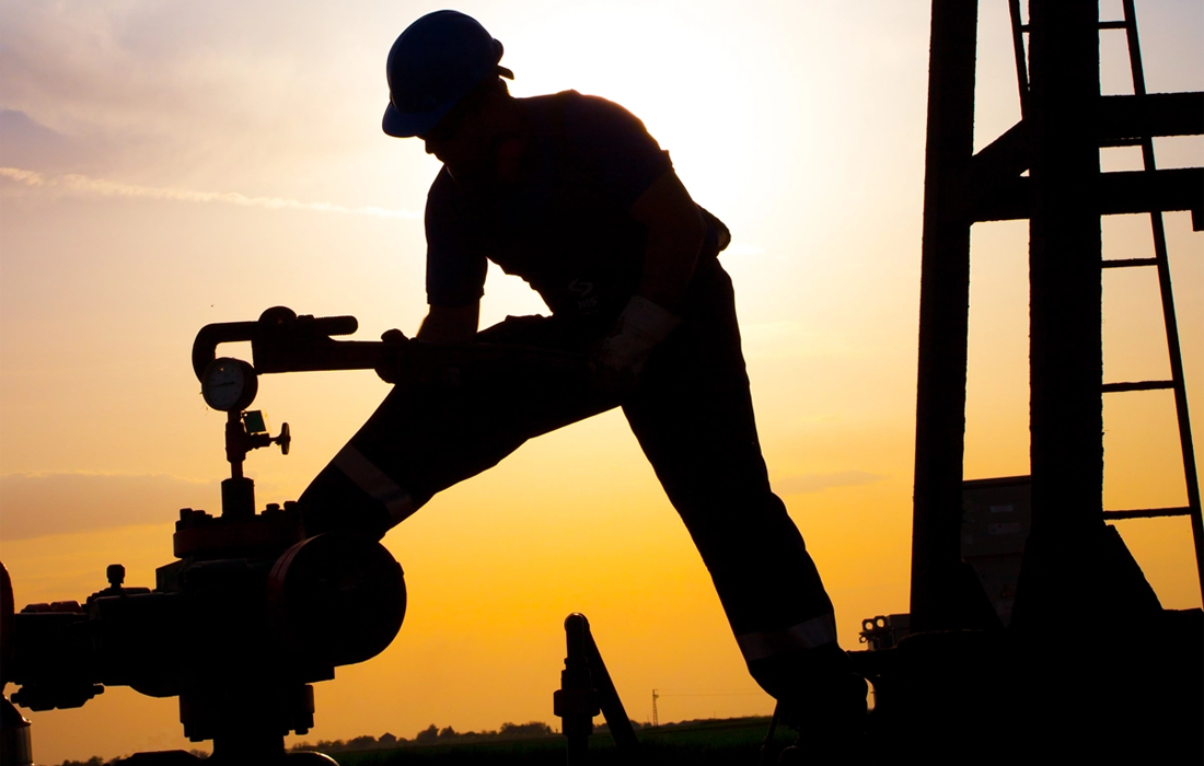 man working on oil pump
